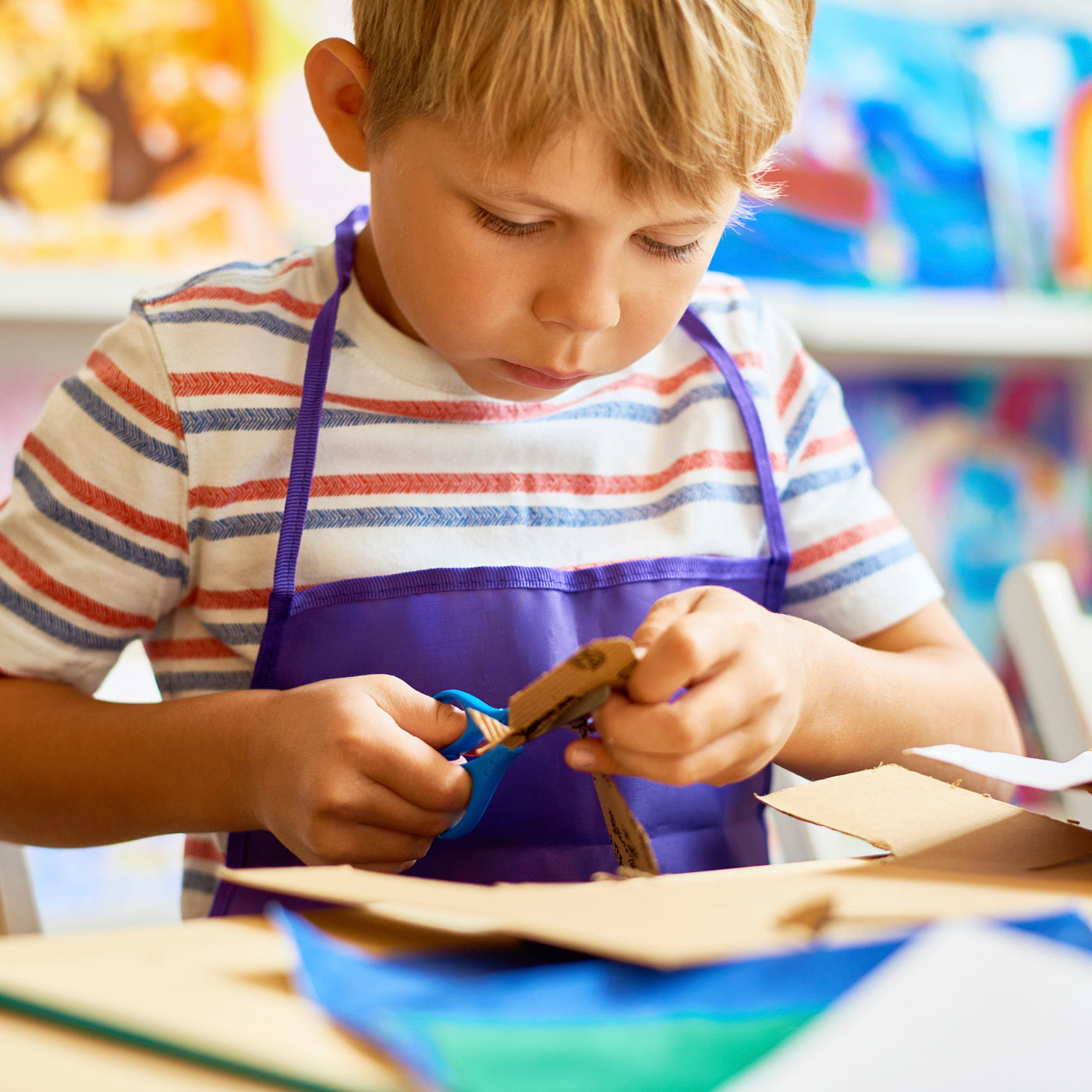 boy cutting an activity sheet