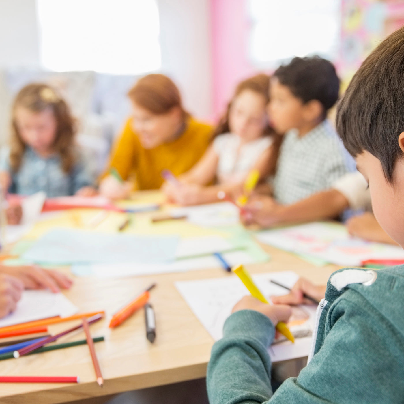 group of kids coloring on paper